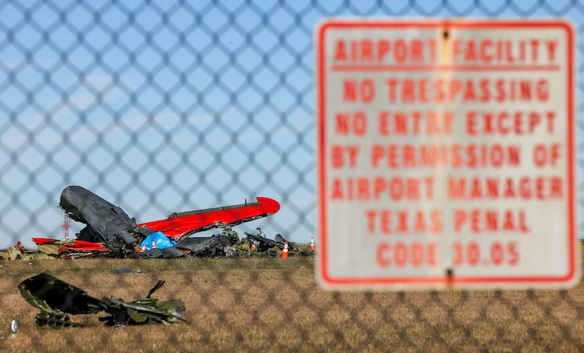 Debris lays scattered around a damaged plane at the Dallas Executive Airport on Sunday, Nov....