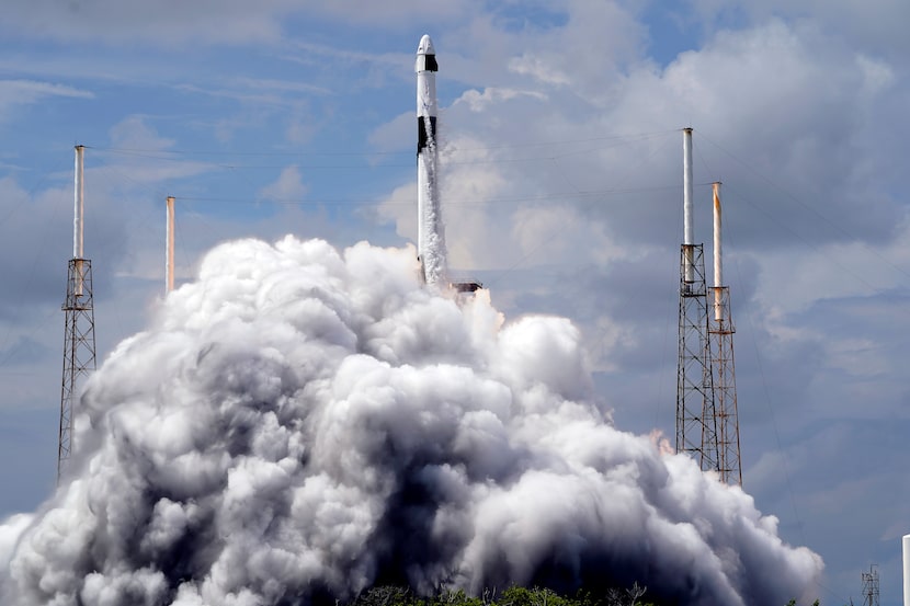 A SpaceX Falcon 9 rocket, with a crew of two astronauts, lifts off from launch pad 40 at the...