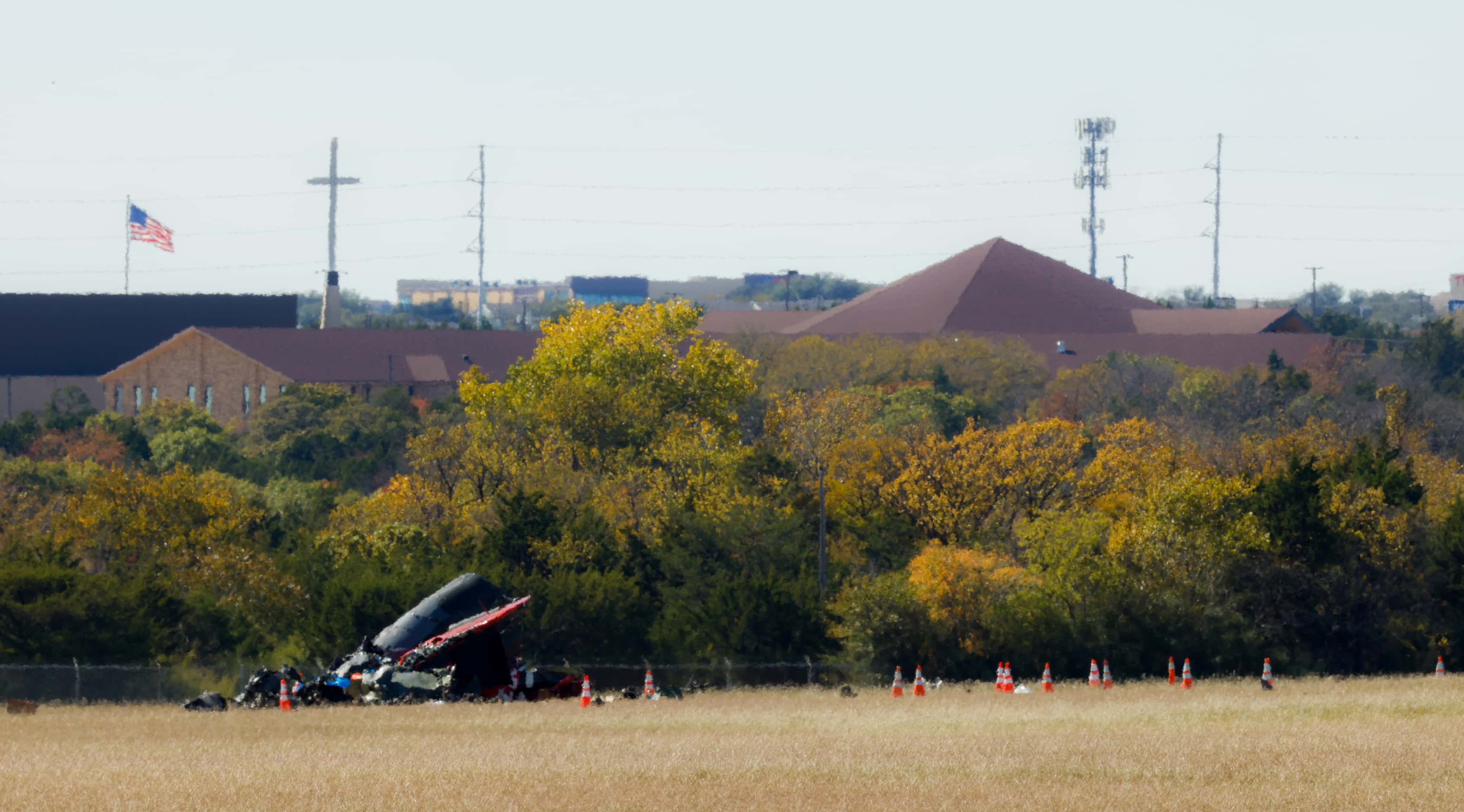 Debris lays scattered around a damaged plane at the Dallas Executive Airport on Sunday, Nov....