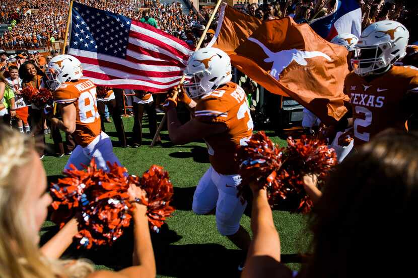 The Texas Longhorns enter the stadium before a college football game between the University...
