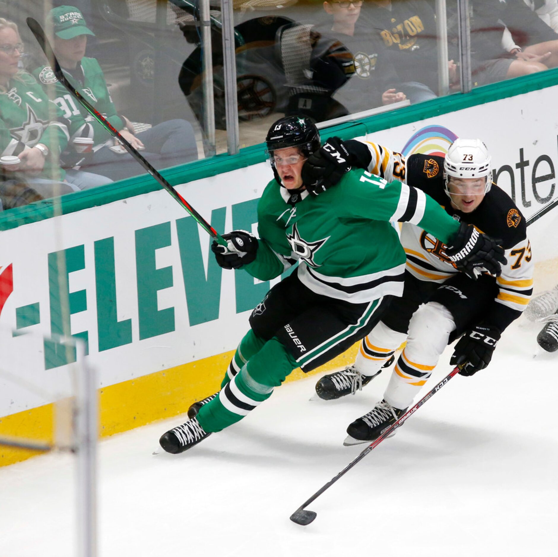 Dallas Stars center Mattias Janmark (13) and Boston Bruins defenseman Charlie McAvoy (73) go...