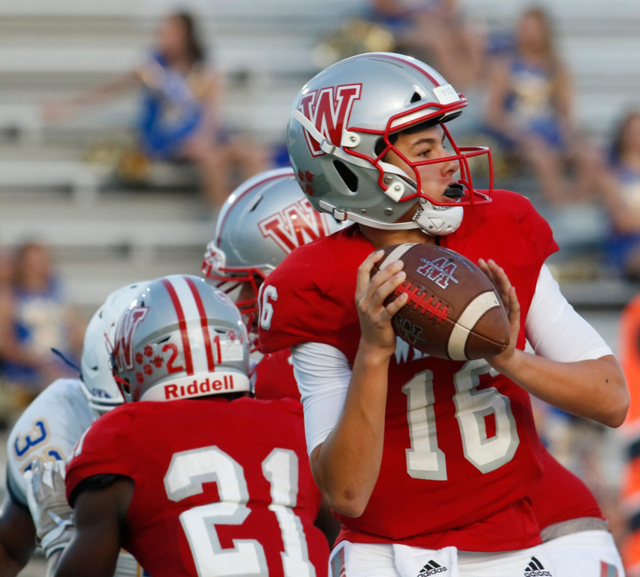 Dallas Woodrow Wilson quarterback Sam Fennegan (16) prepares to launch a long pass downfield...