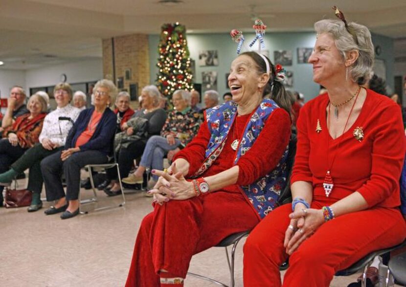 
Susan Betz, left, and her daughter, Diana Betz, both dressed in holiday colors and...