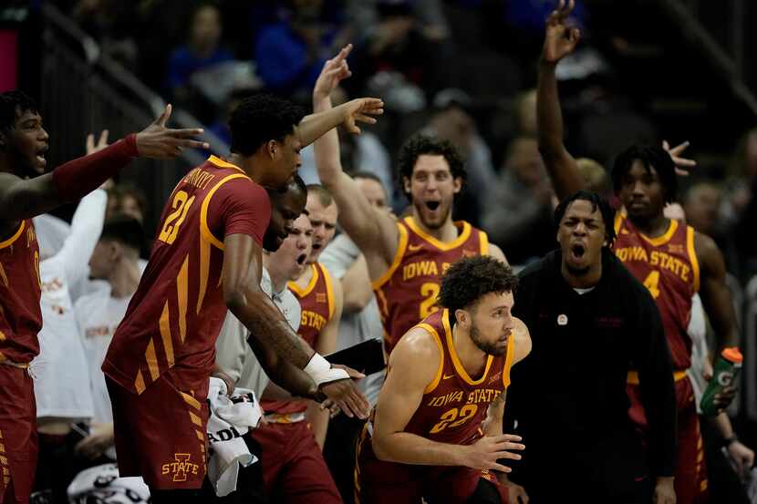The Iowa State bench celebrates a three-point basket by guard Gabe Kalscheur (22) during the...