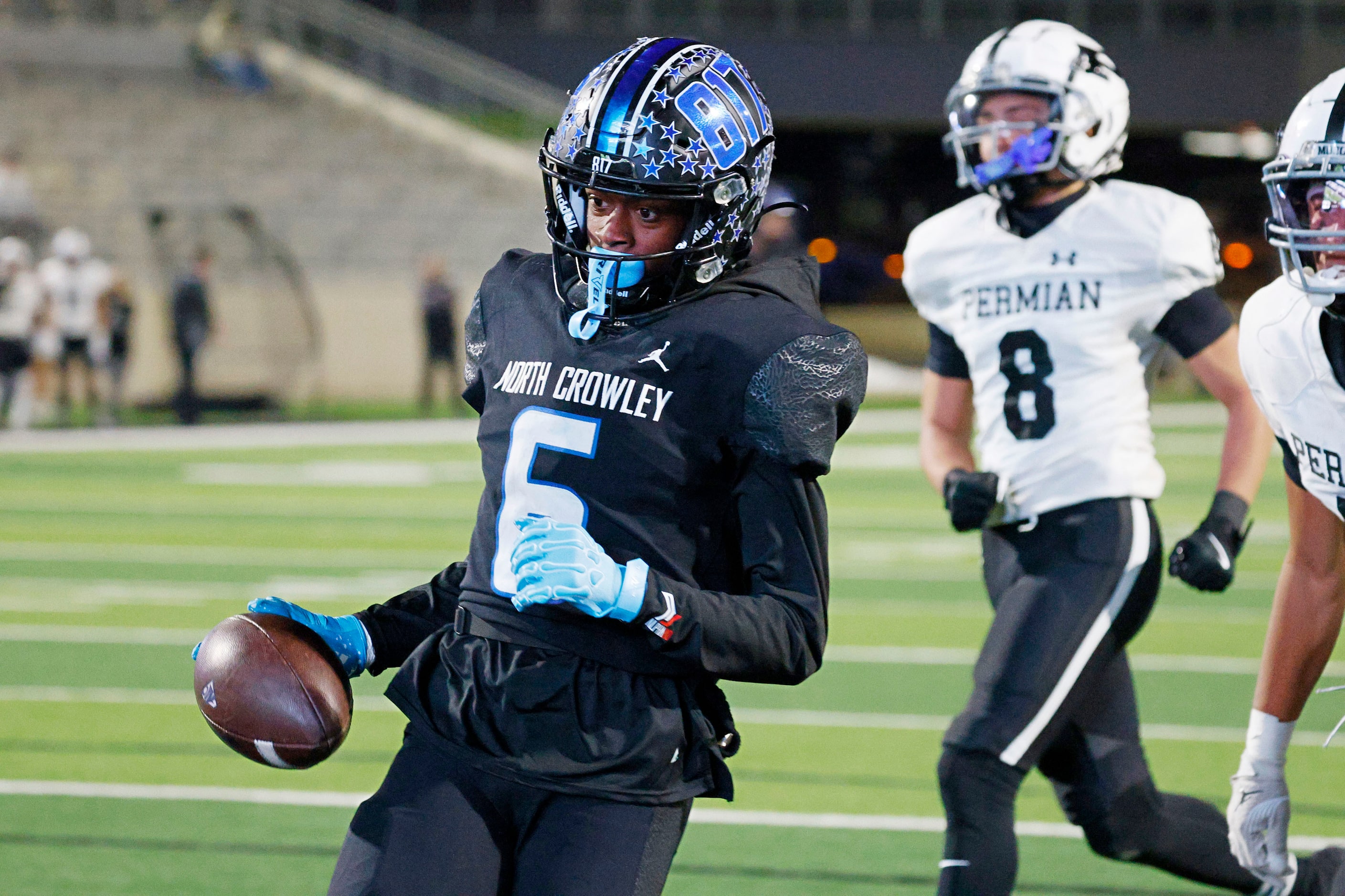 North Crowley's Quentin Gibson scores a touchdown as Permian's Izeyah Mccoy (8) looks on in...