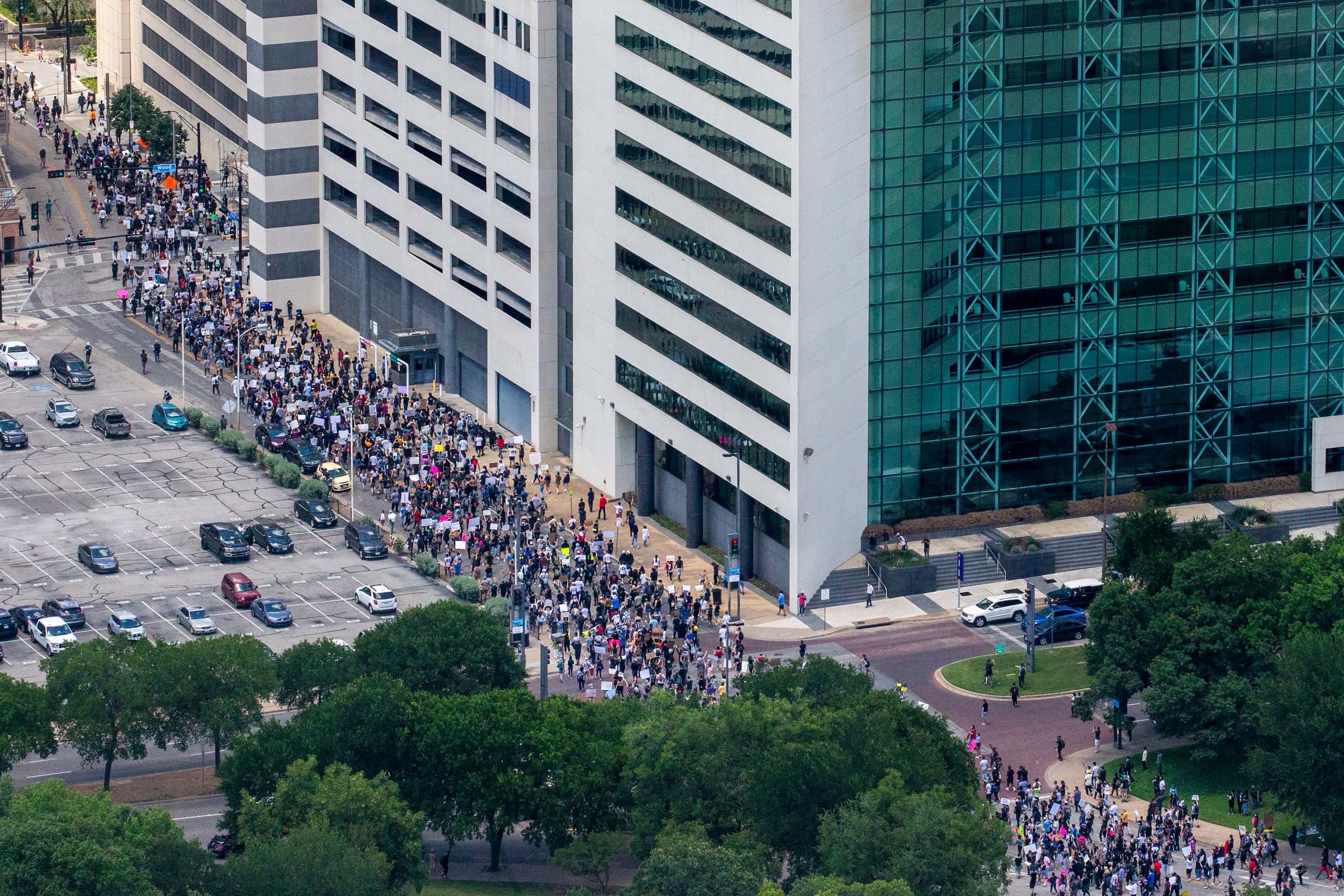 Protesters march throughout the downtown streets of Dallas during a demonstration denouncing...