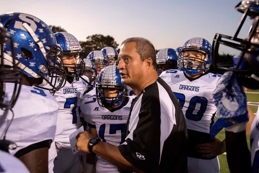Seagoville head coach Andy Gutierrez encourages his players before a high school football...