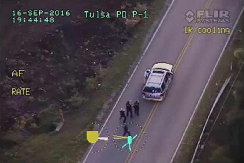 In this image made from a Sept. 16 police video, Terence Crutcher (top) is pursued by police...