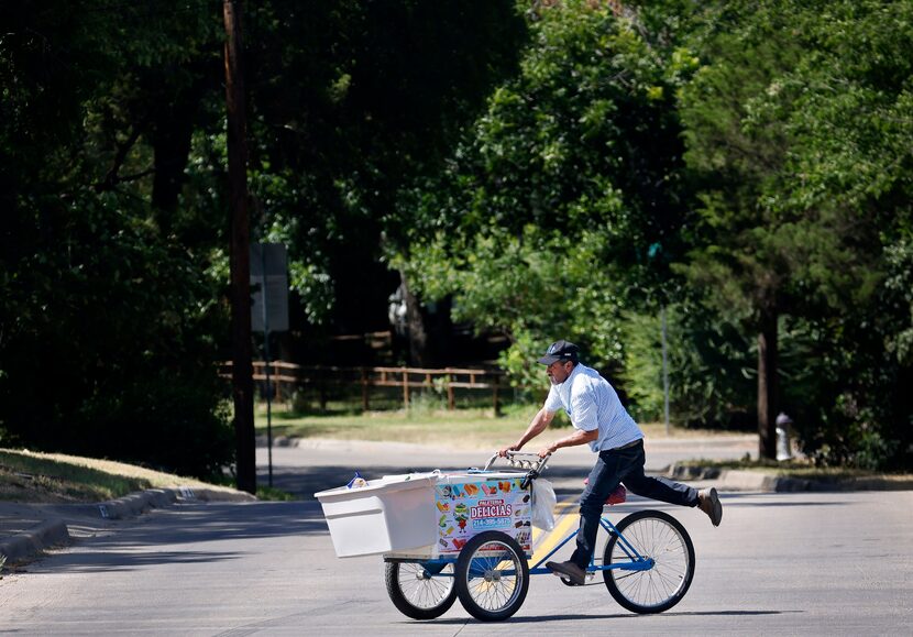 After pushing his cart uphill, paletero Leonardo German Trejo, a 53-year-old paleta vendor...