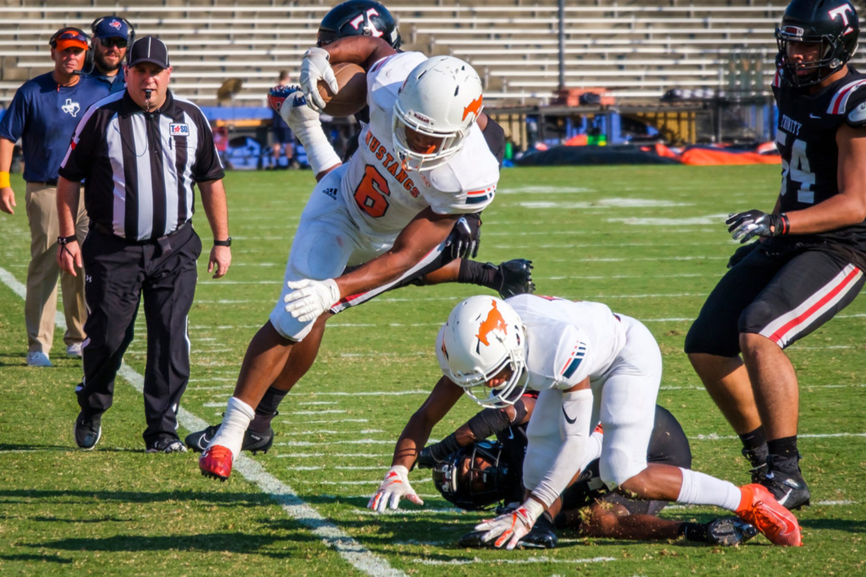 Sachse running back  Shon Coleman (6) is knocked out of bounds by the Euless Trinity defense...