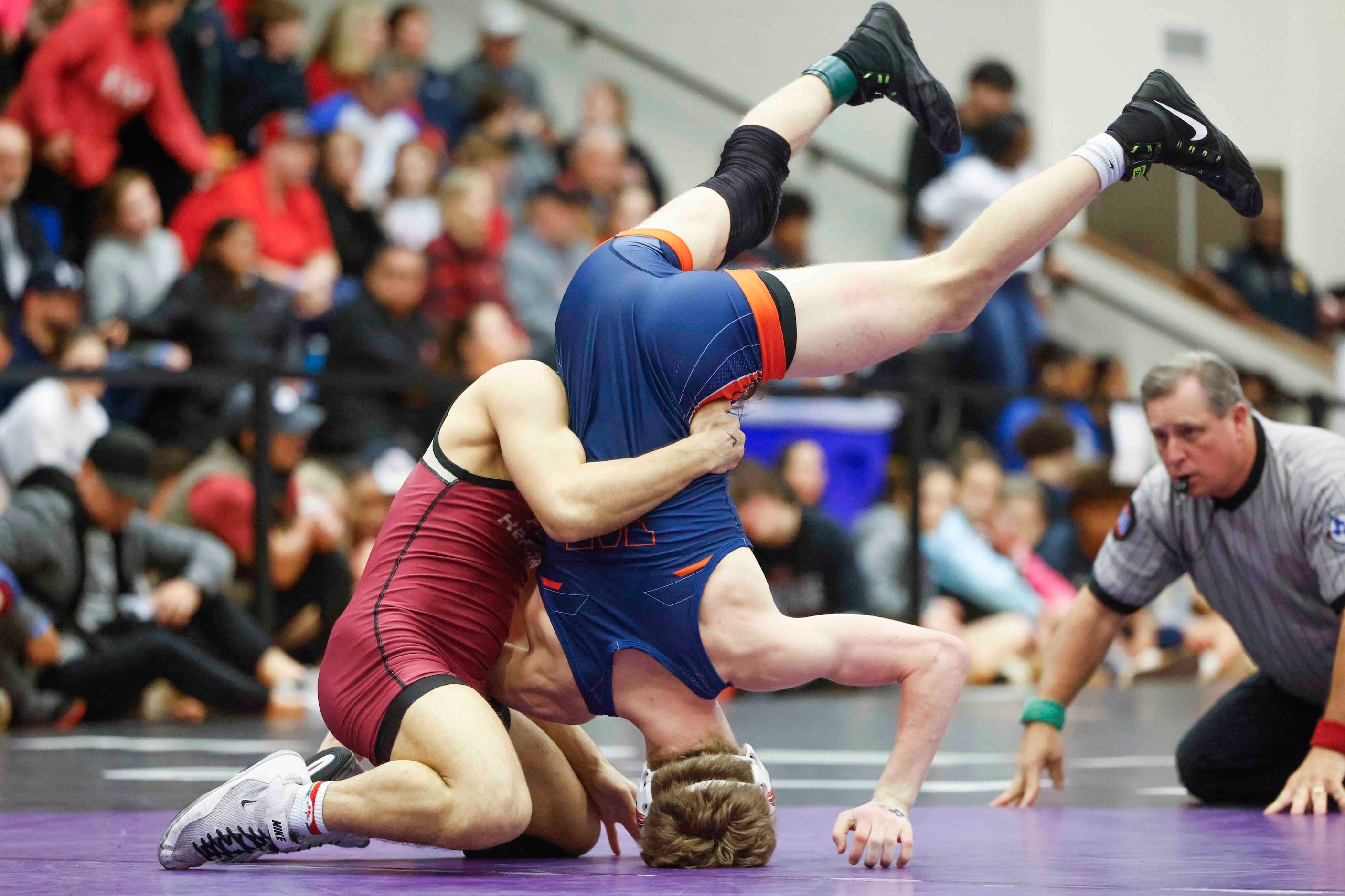 Michael Brennan of Frisco Wakeland wrestles against  Kai Mcdermott of Frisco Heritage (left)...