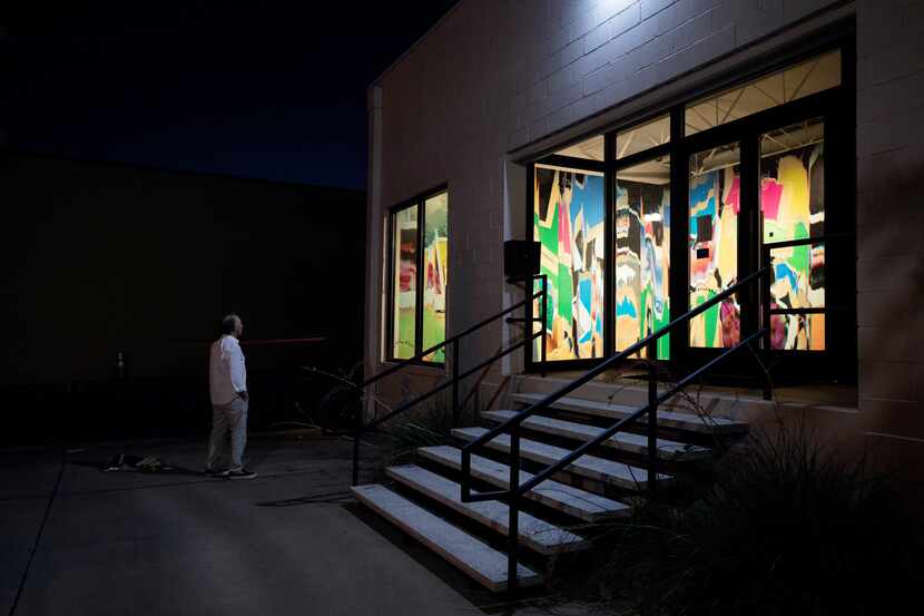 Gallery owner Barry Whistler and his dog Billie check out artist Liz Trosper's 34-foot mural...