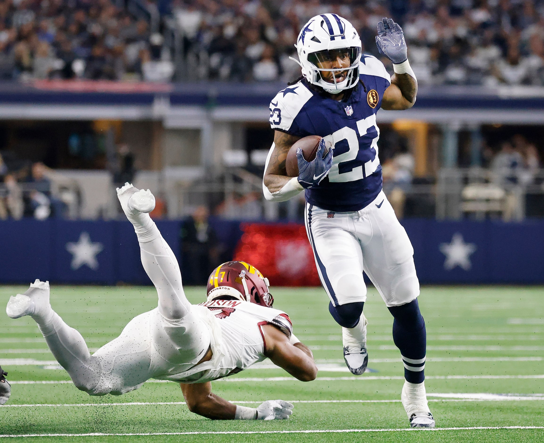 Washington Commanders linebacker Khaleke Hudson (47) attempts to tackle Dallas Cowboys...