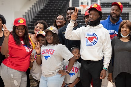 South Oak Cliff quarterback Kevin Henry-Jennings, right, does the SMU pony ear hand sign...