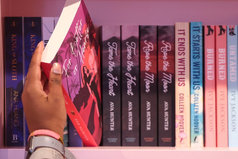 Customers skim through the bookshelves during the grand opening of Blush Bookstore on,...