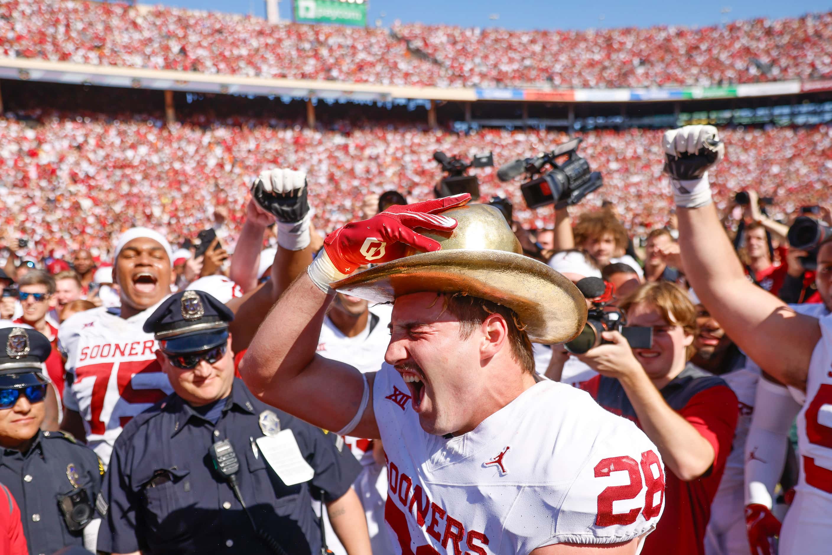 Oklahoma linebacker Danny Stutsman wears the gold hat after winning the Red River Rivalry...