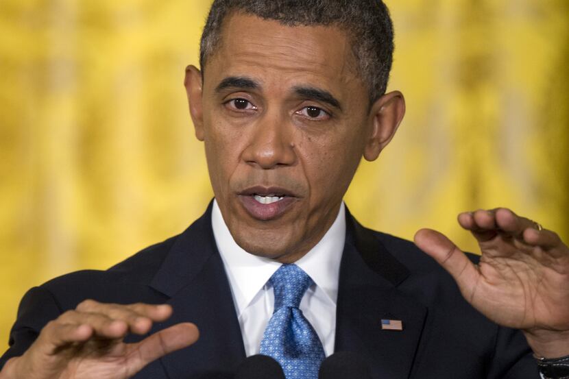 President Barack Obama gestures as he speaks Monday during the last news conference of his...