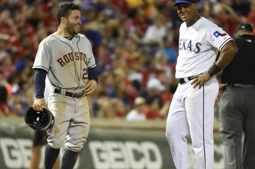 Houston Astros second baseman Jose Altuve (27) laughs with Texas Rangers third baseman...