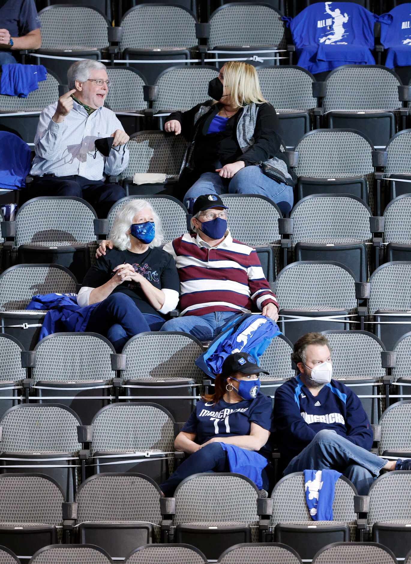 Dallas Mavericks fans mask up before the teams game against the Oklahoma City Thunder at the...