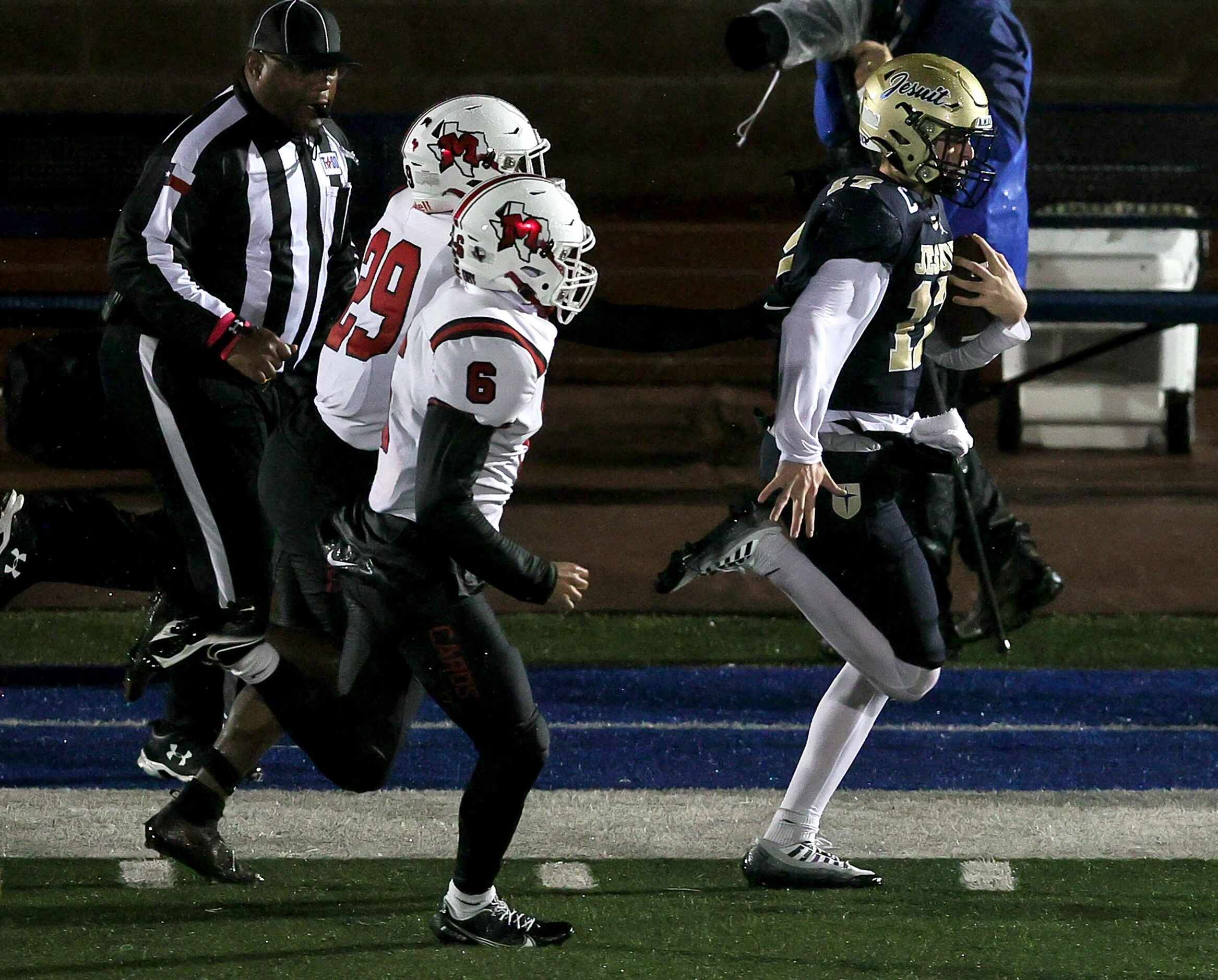 Jesuit quarterback Charlie Schmidt (17) goes down the sideline past MacArthur defensive back...