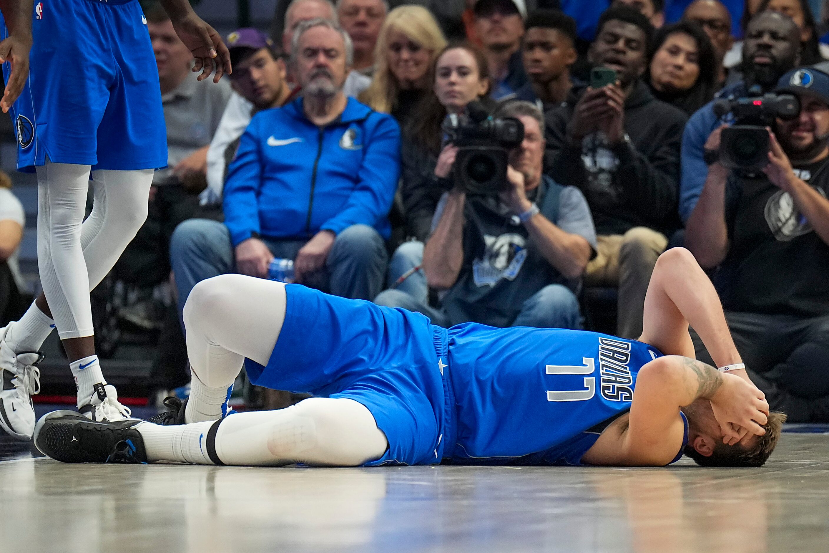 Dallas Mavericks guard Luka Doncic (77) reacts after being hit in the face on a drive...