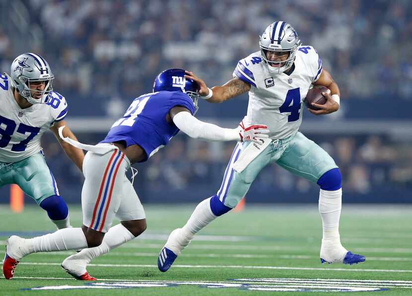 Dallas Cowboys quarterback Dak Prescott (4) keeps the ball and runs against New York Giants...