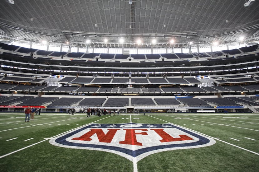 The NFL logo, painted at mid-field as crews worked to prepare Cowboys Stadium in Arlington,...