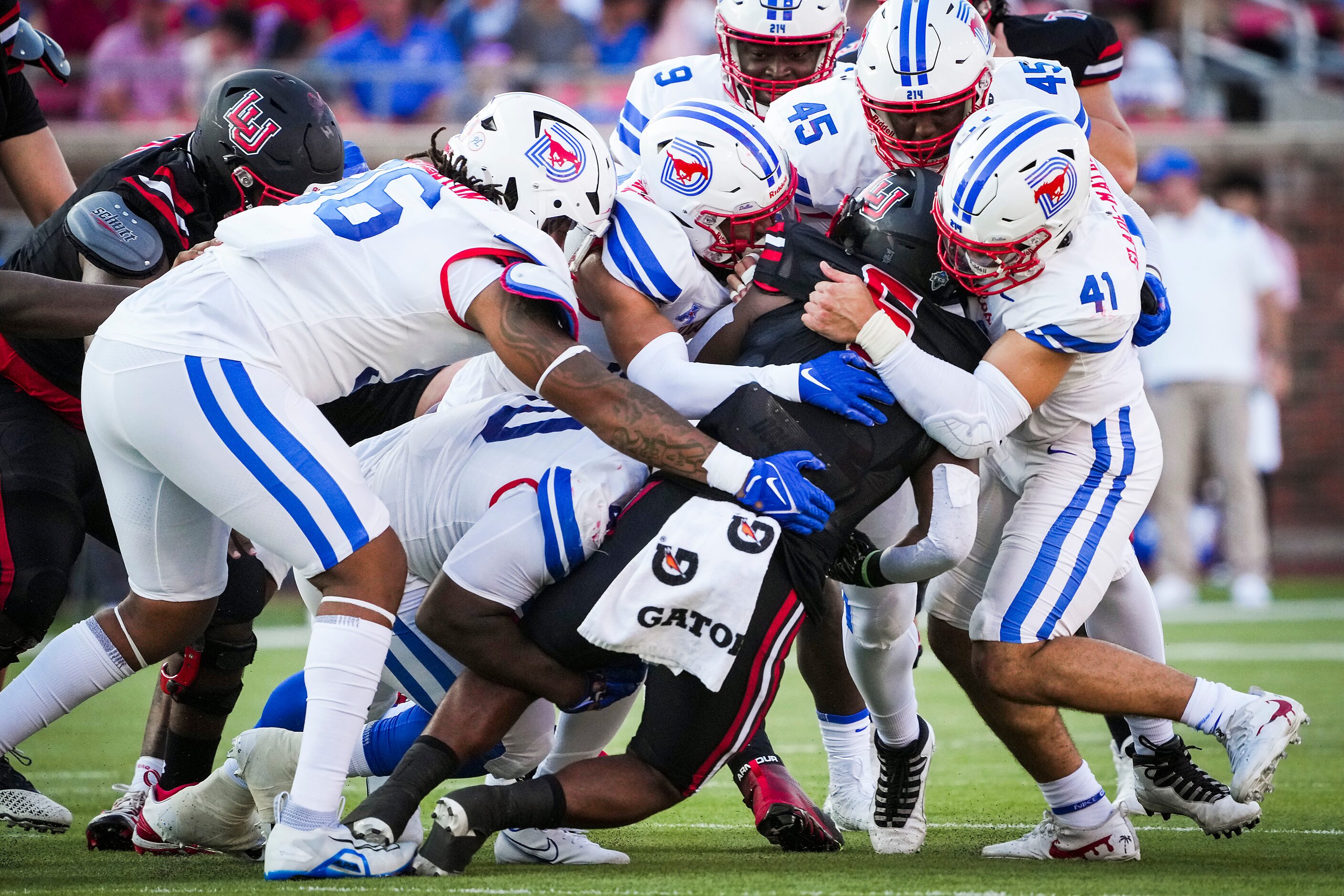 Lamar Cardinals running back Khalan Griffin (6) is smothered by SMU defensive tackle DeVere...