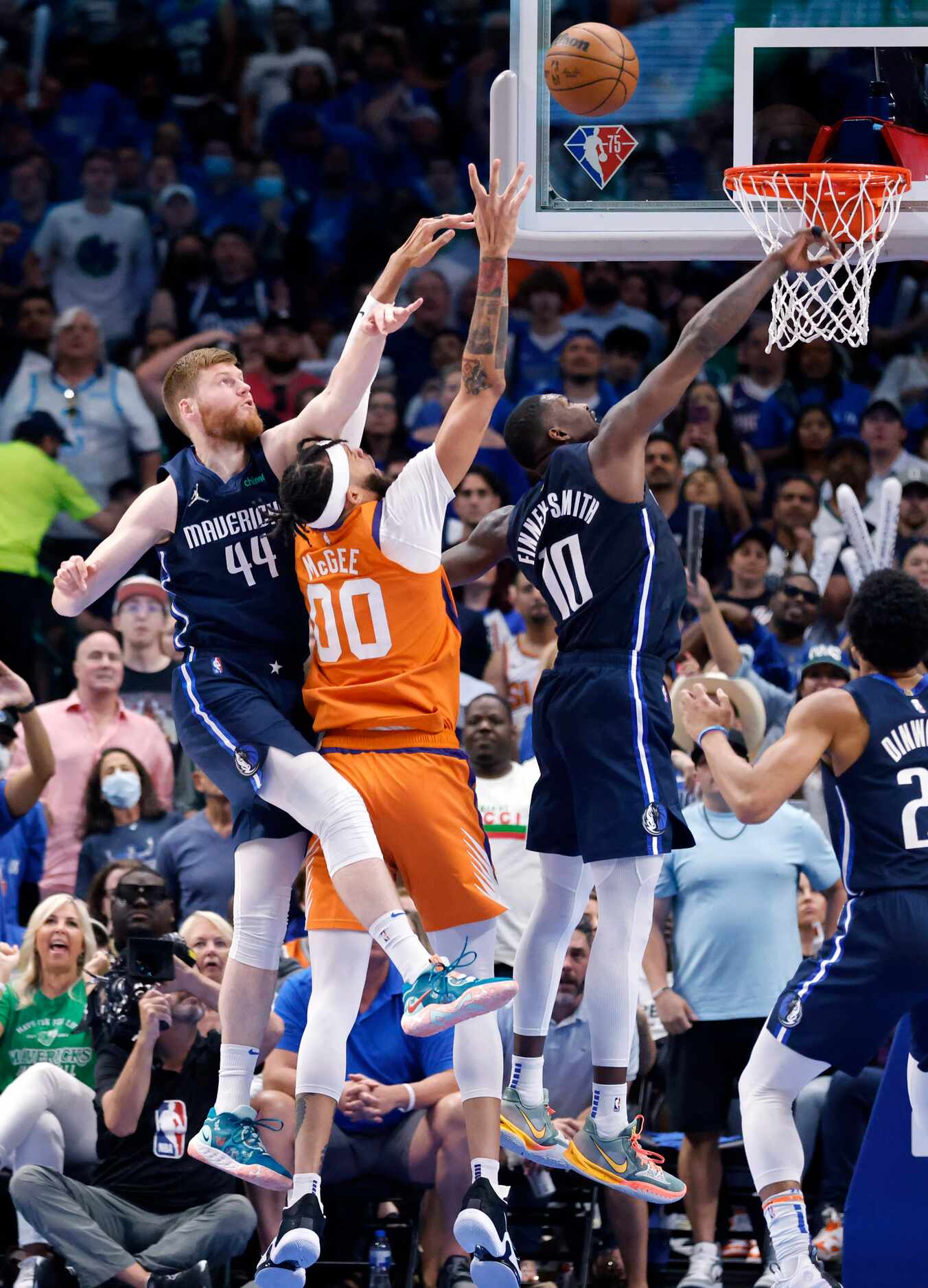 Dallas Mavericks forward Davis Bertans (44) and forward Dorian Finney-Smith (10) battle for...