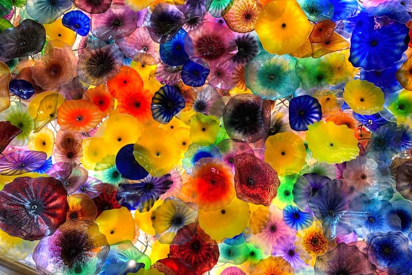 Artist Dale Chihuly created around 2,000 glass flowers for his ceiling installation inside...