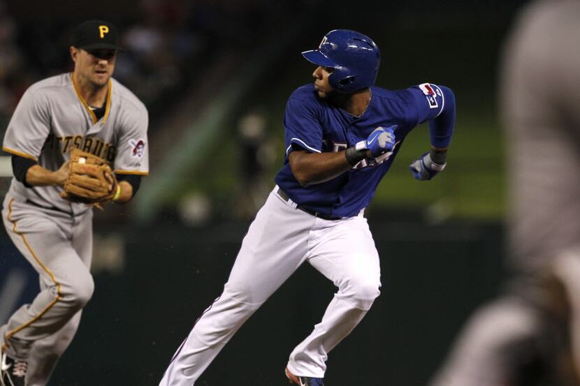 The Texas Rangers' Elvis Andrus is chased by Pittsburgh Pirates shortstop Jordy Mercer,...