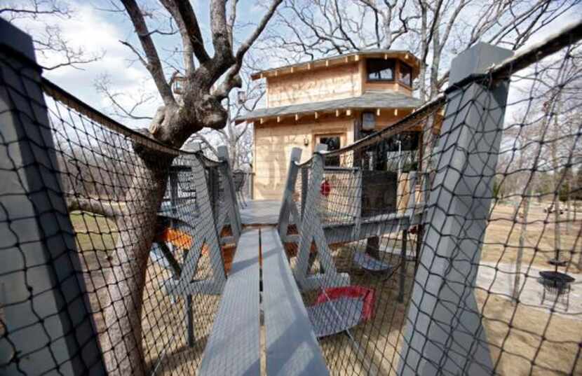
The rope bridge outside a treehouse built by Pete Nelson for Bobby and Marty Page in...