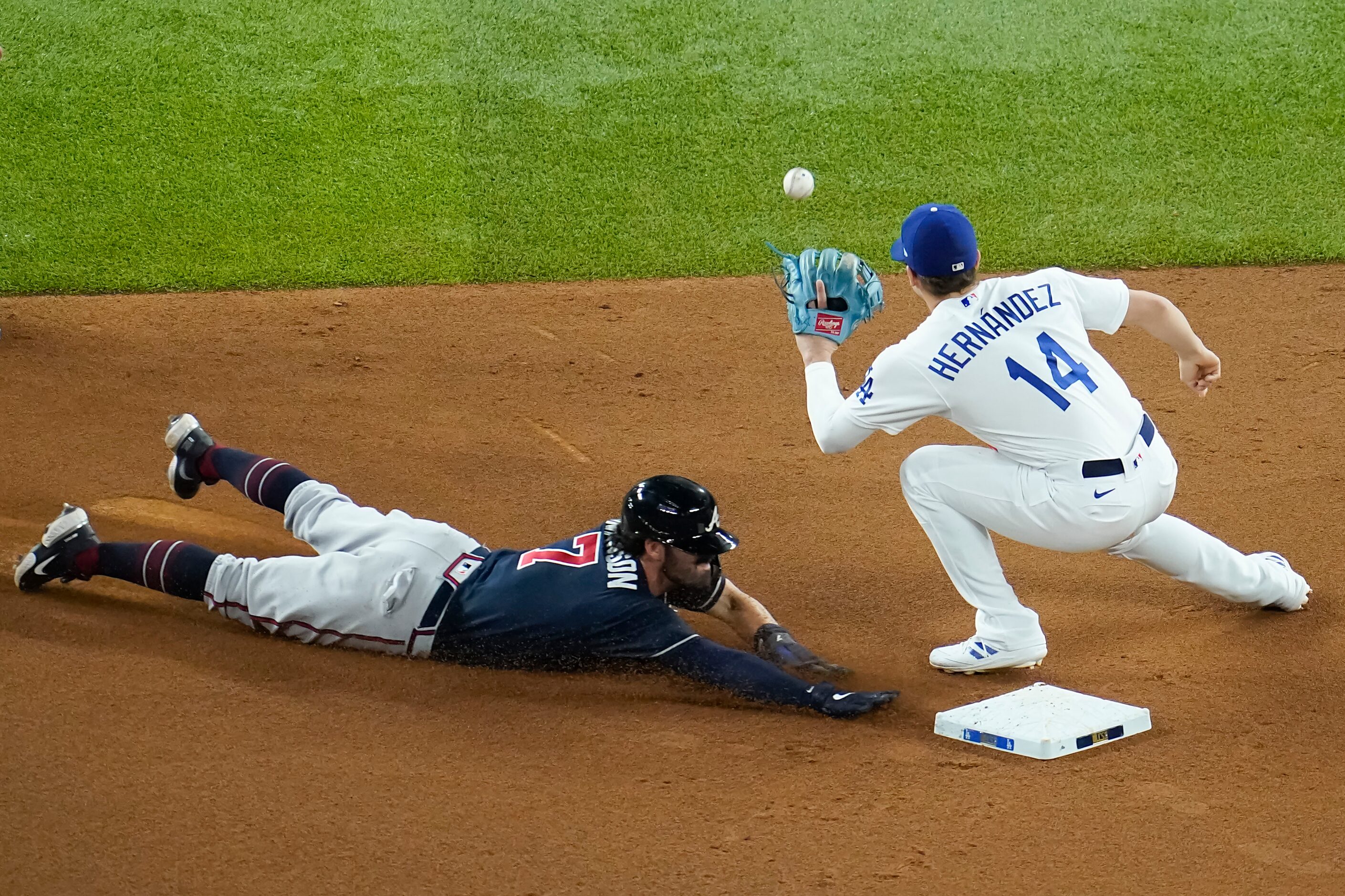 Atlanta Braves shortstop Dansby Swanson (7) steals second base ahead of the throw to Los...