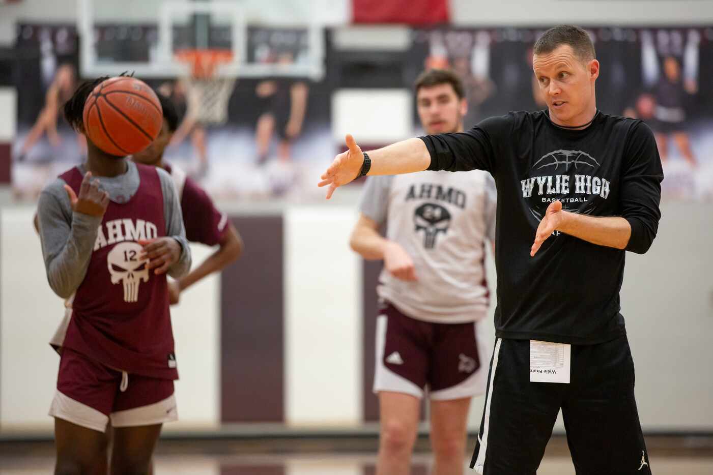 Wylie High School head basketball coach Stephen Pearce directs players in a drill during...