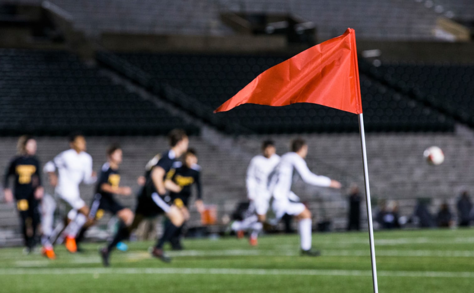 A red sideline flag waves at a corner of the field during a soccer game between Forney High...