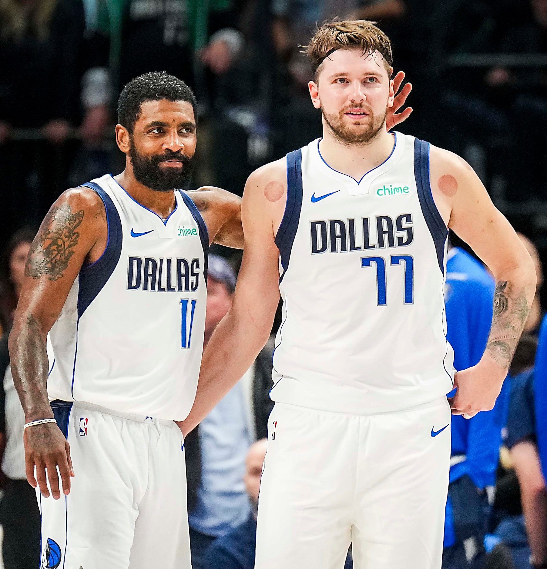 Dallas Mavericks guard Kyrie Irving (11) hugs guard Luka Doncic (77) during the second half...