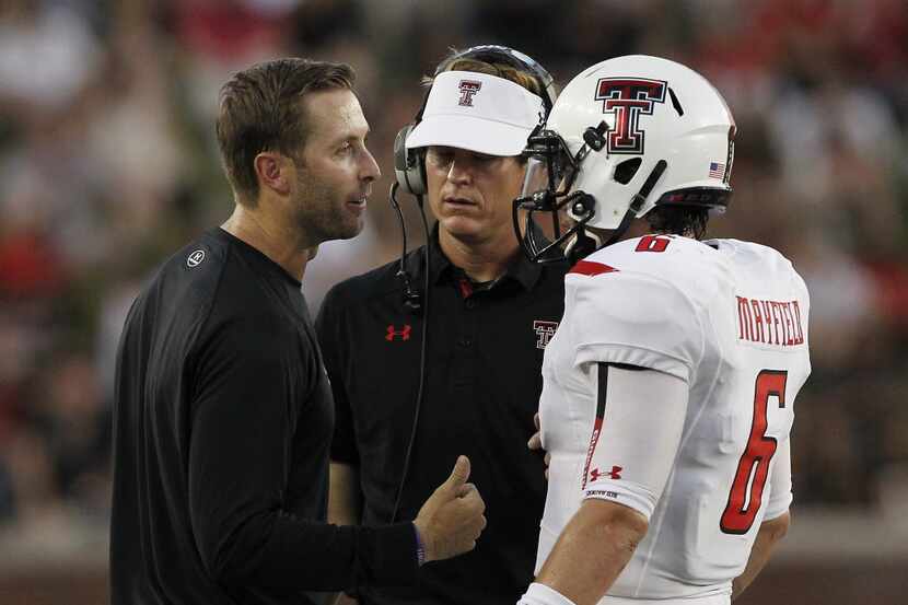 Texas Tech Red Raiders head coach Kliff Kingsbury talks with Texas Tech Red Raiders...