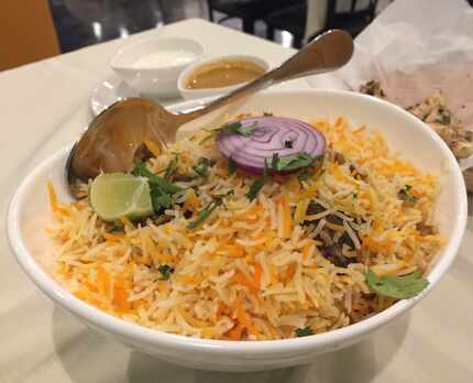Goat biryani at Touch Nine restaurant in Irving, served with tangy raita and a gravy.