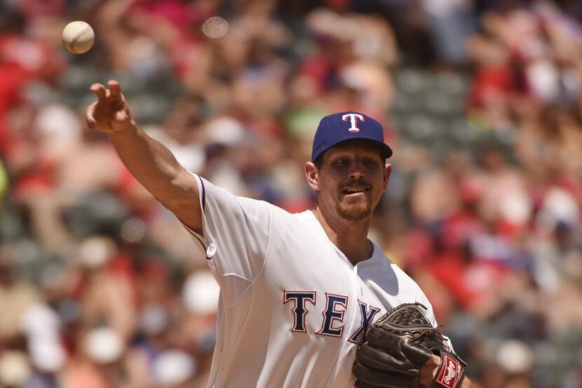 Texas Rangers starting pitcher Nick Tepesch (23) throws to first on a pickoff attempt...