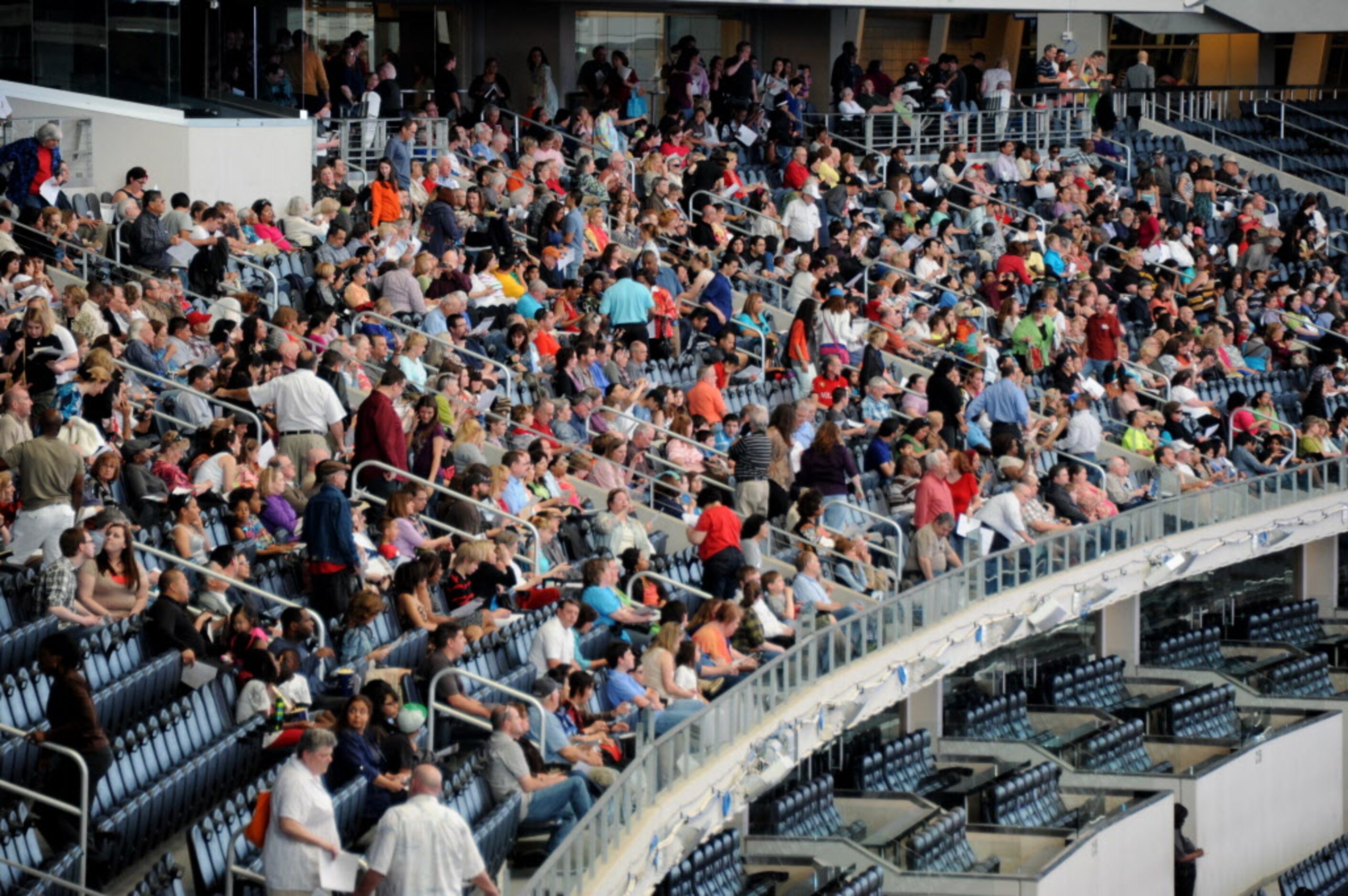 Attendees grab a bite to eat and find their seats quickly to get a good view at the Dallas...