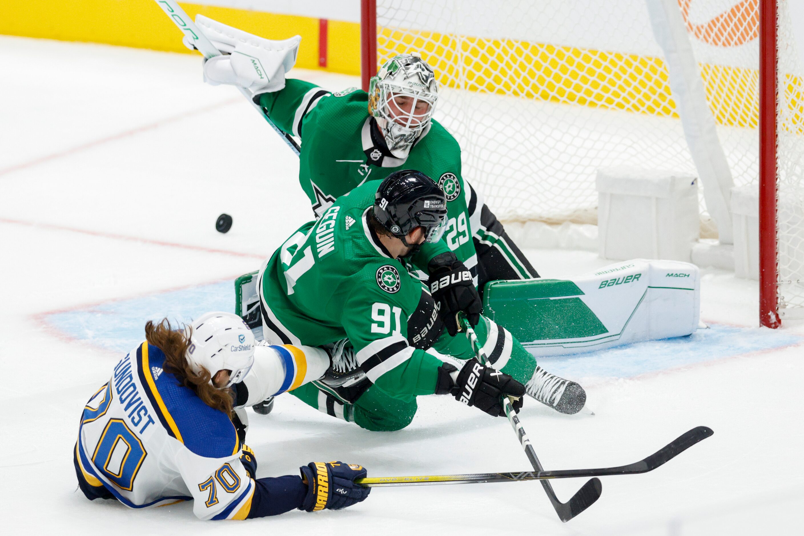 St. Louis Blues right wing Oskar Sundqvist (70) falls to the ice with Dallas Stars center...