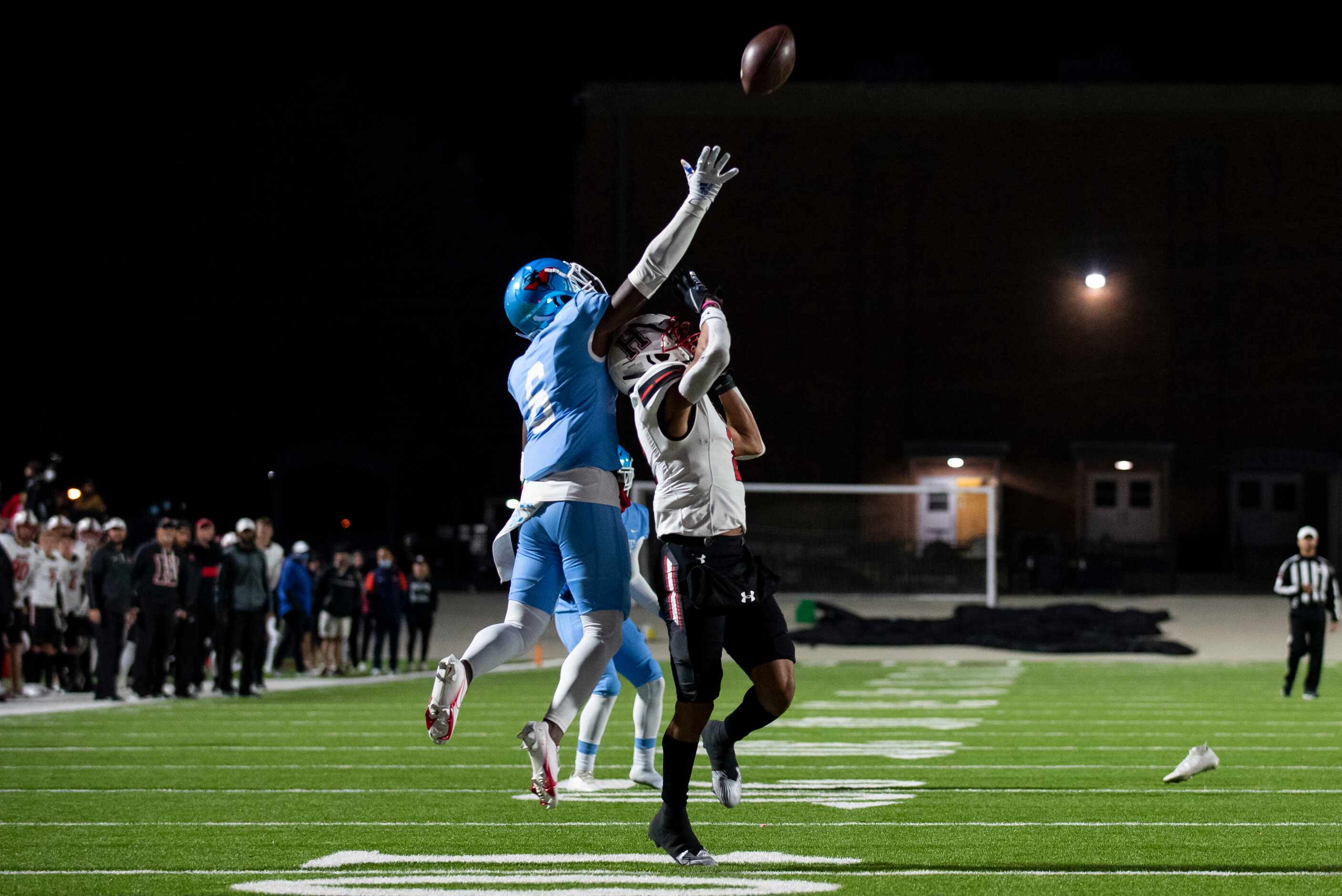 From left, Skyline senior Anthony Davis (6) leaps up next to Heath senior Jordan Nabors (2)...