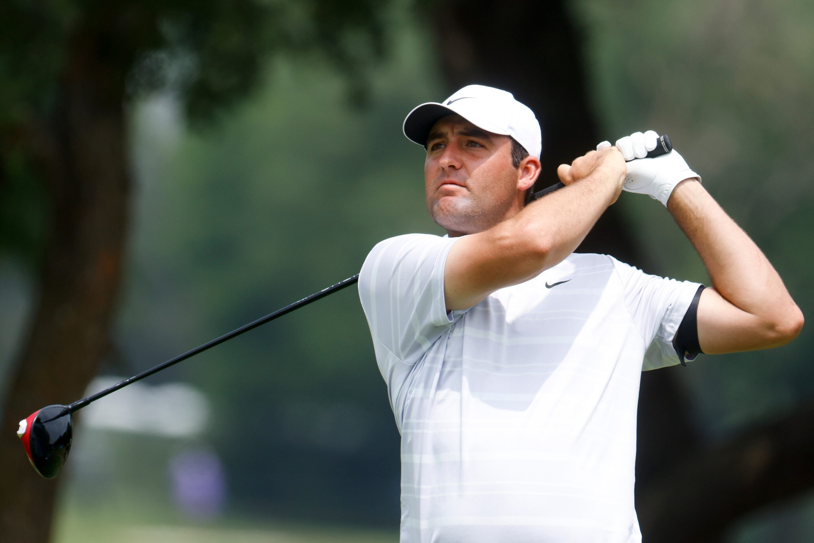 Scottie Scheffler of United States watches as he tees of on the ninth hole during the second...