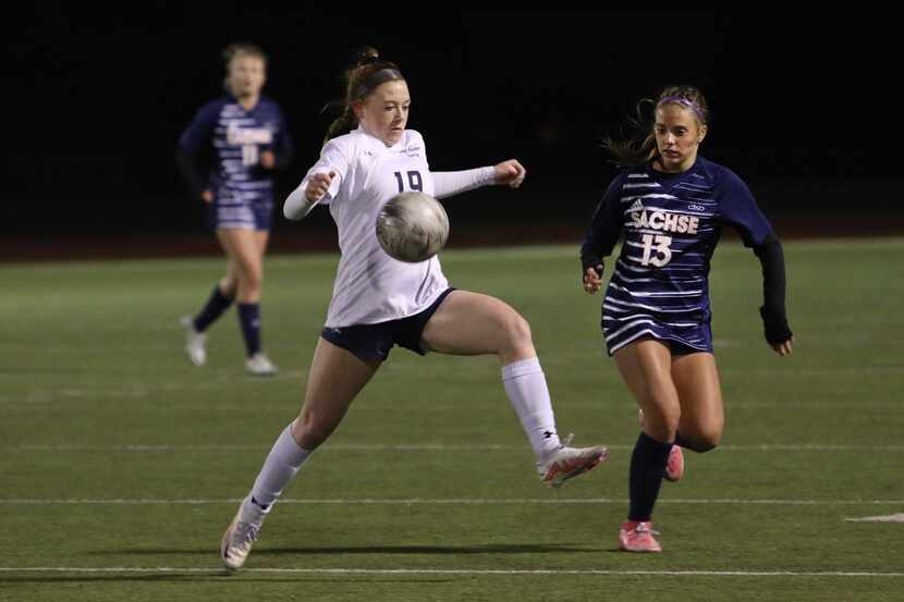 Wylie East High School player #19, Karlee Leary, and Sachse High School player #13, Clara...