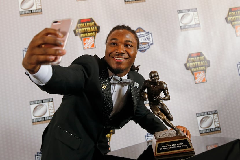 Texas running back D'Onta Foreman takes a selfie with the Doak Walker Award after winning it...
