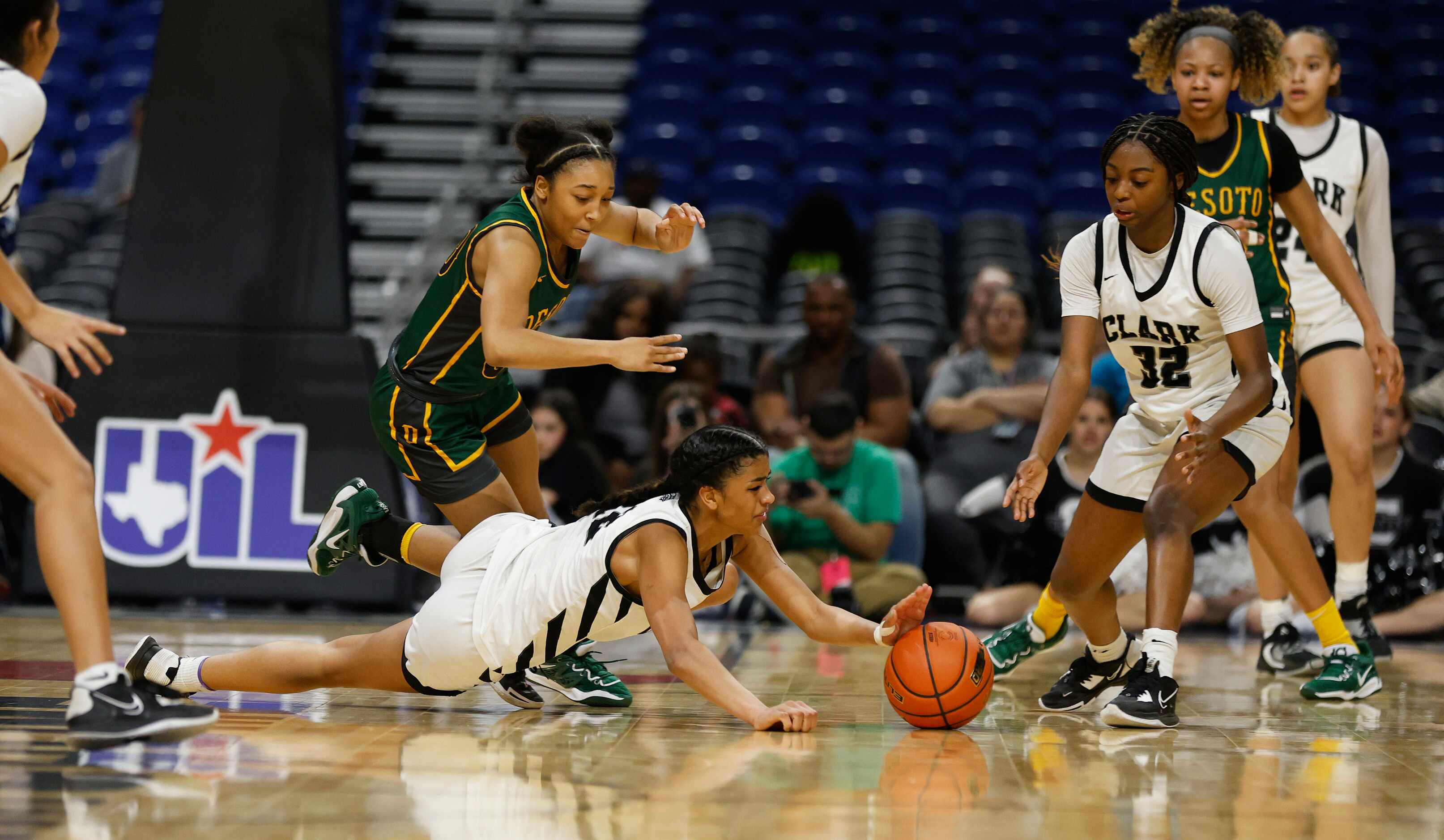 Clark Cougars’ Adrianna Roberson (12) dives for a loose ball in front of Desoto Mylasia...