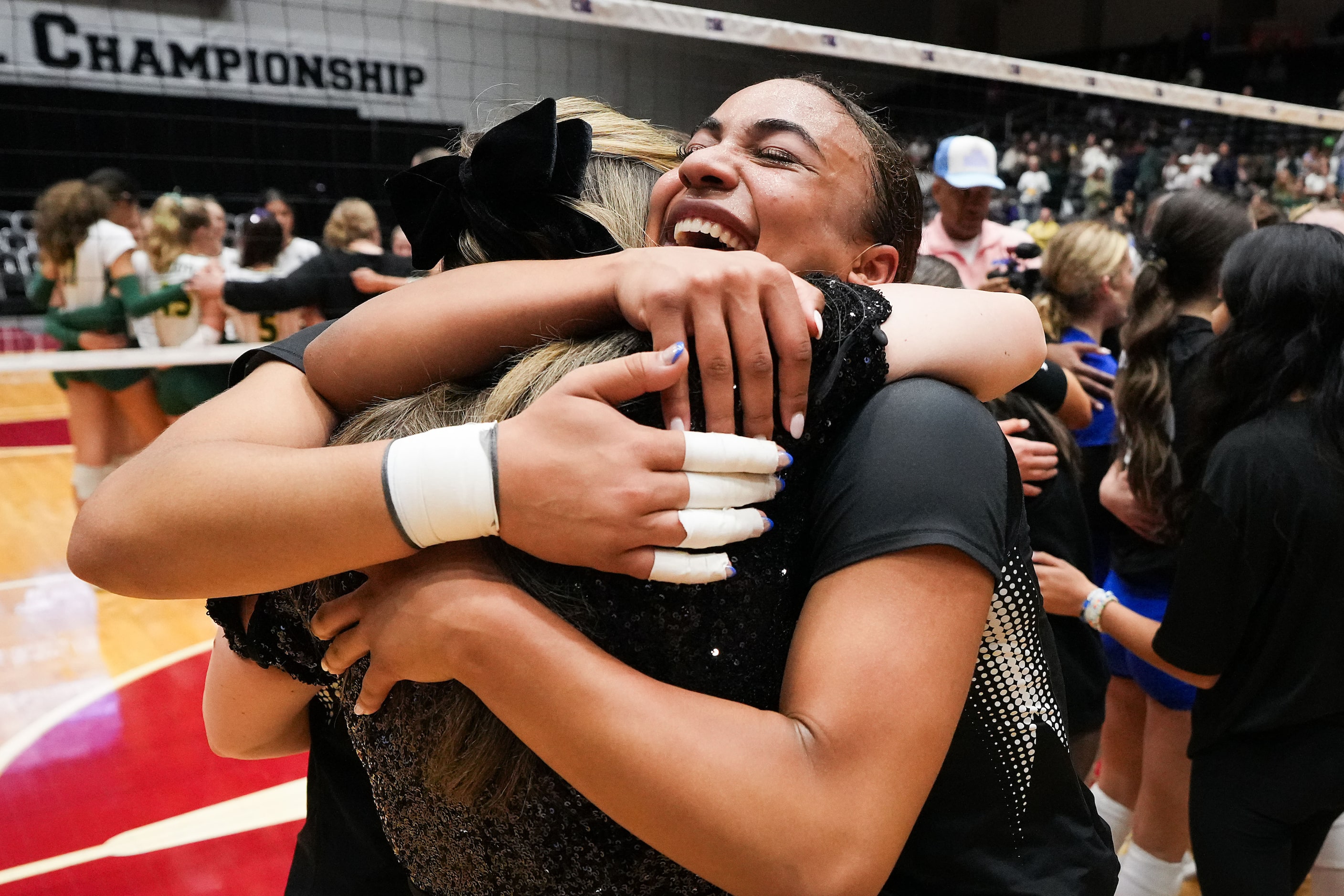 Trophy Club Byron Nelson's Sydnee Peterson  hugs head coach Brianne Groth and her sister...