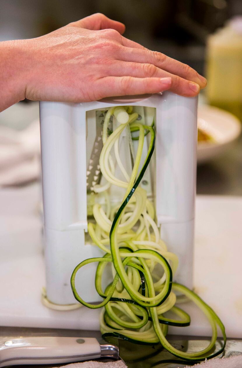 Chef Danyele McPherson makes a zucchini pasta bowl using a spiralizer on Thursday, March 31,...