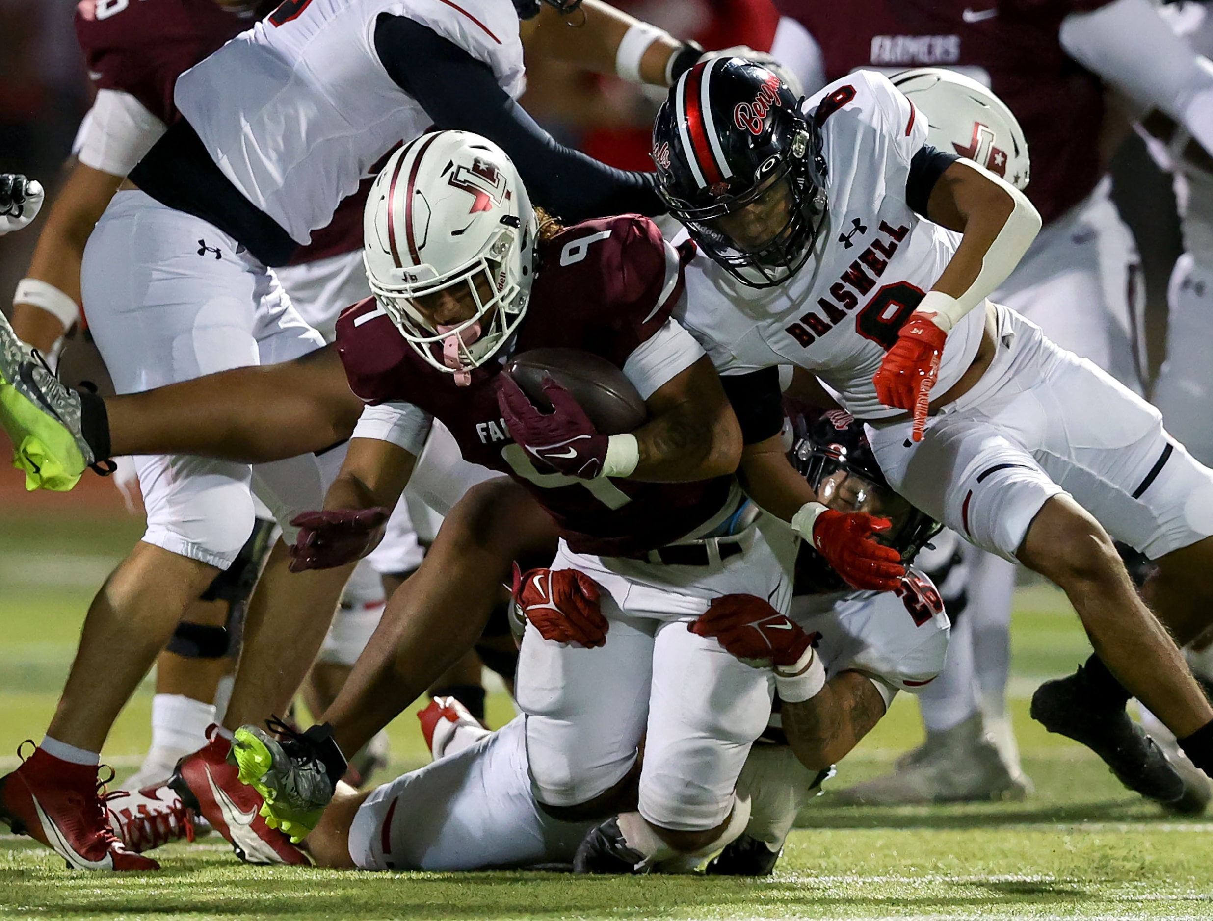 Lewisville running back Tenel Hill (9) dragged down by Denton Braswell linebacker Jacob...