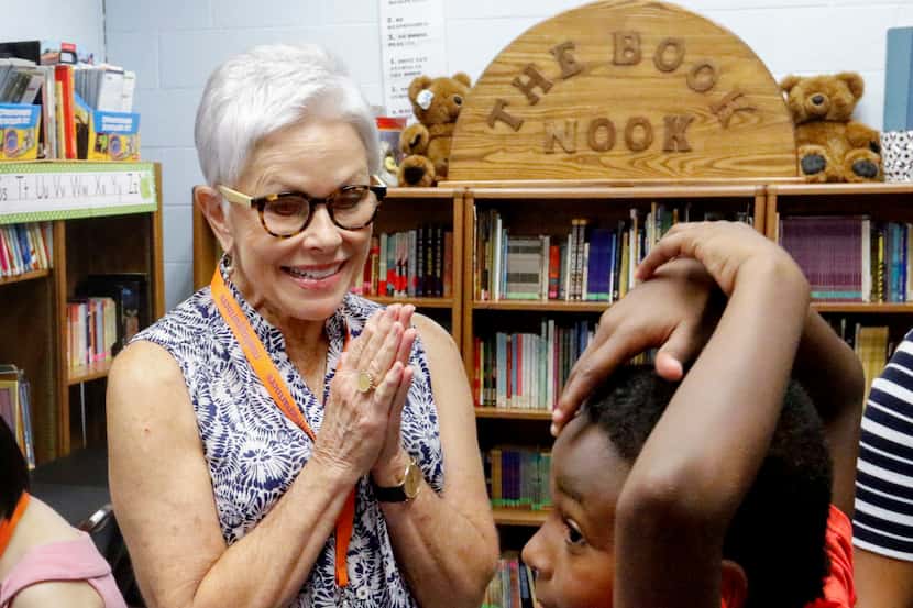 Connie Koehler, 65, a volunteer with Reading Partners, visits with Bradley Williams, 7,...